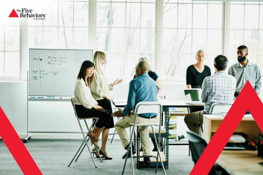 A group working together at a whiteboard. Photo: The Five Behaviors®