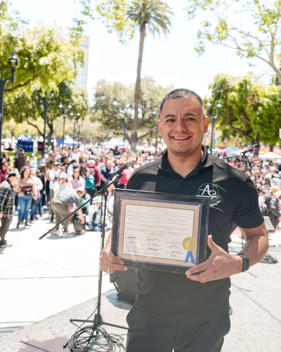 Jose Badillo receiving a community award