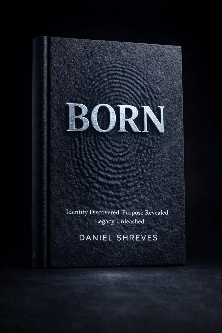 BORN by Daniel Shreves — black leather cover with a fingerprint debossed into it and the title in brushed steel