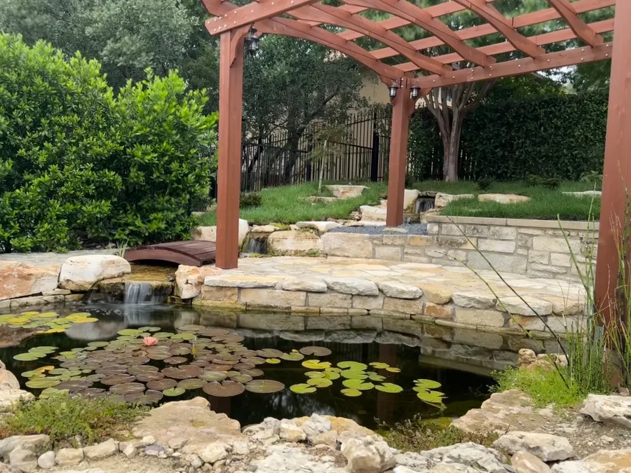 Koi pond under a pergola built by WaterScape, ATX
