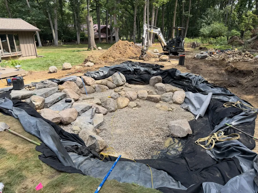 Pond excavation with liner and underlayment going in