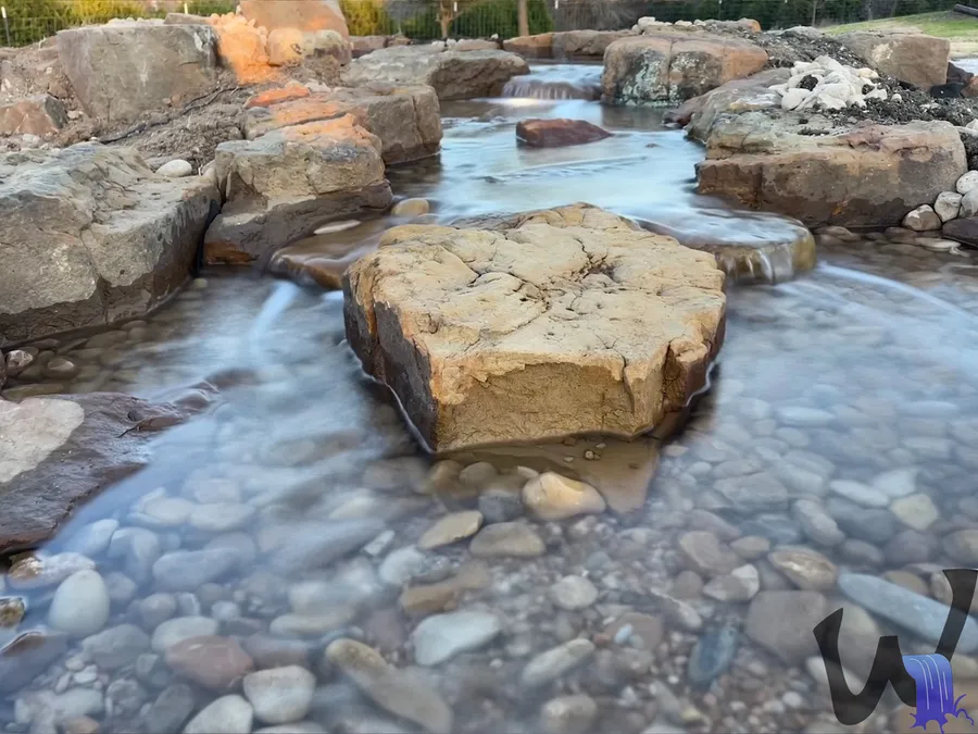 Stream flowing between large boulders