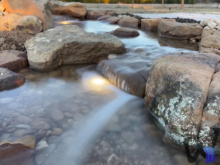 Stream lit at dusk with underwater lighting