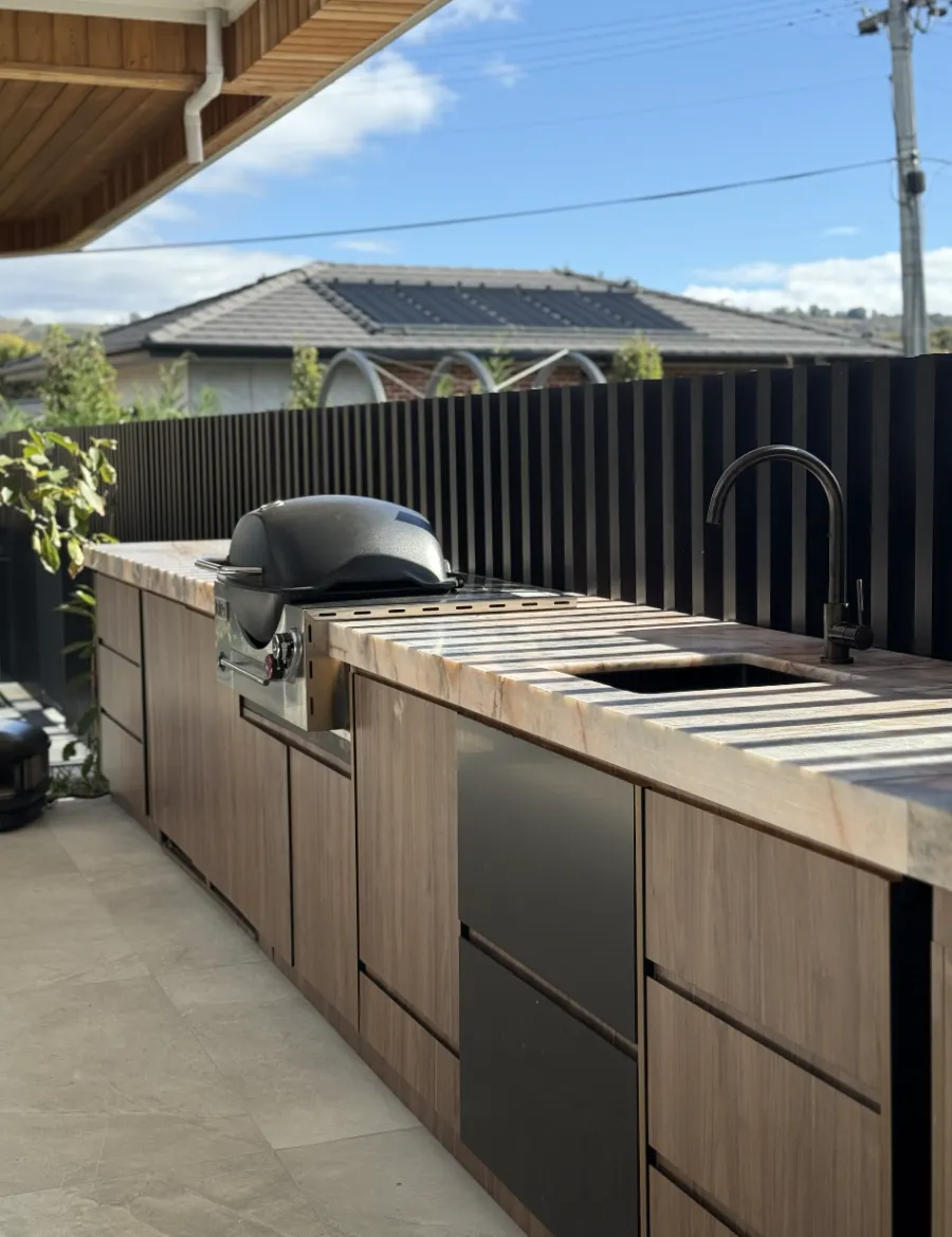 Outdoor kitchen with stone benchtop protected by surface film