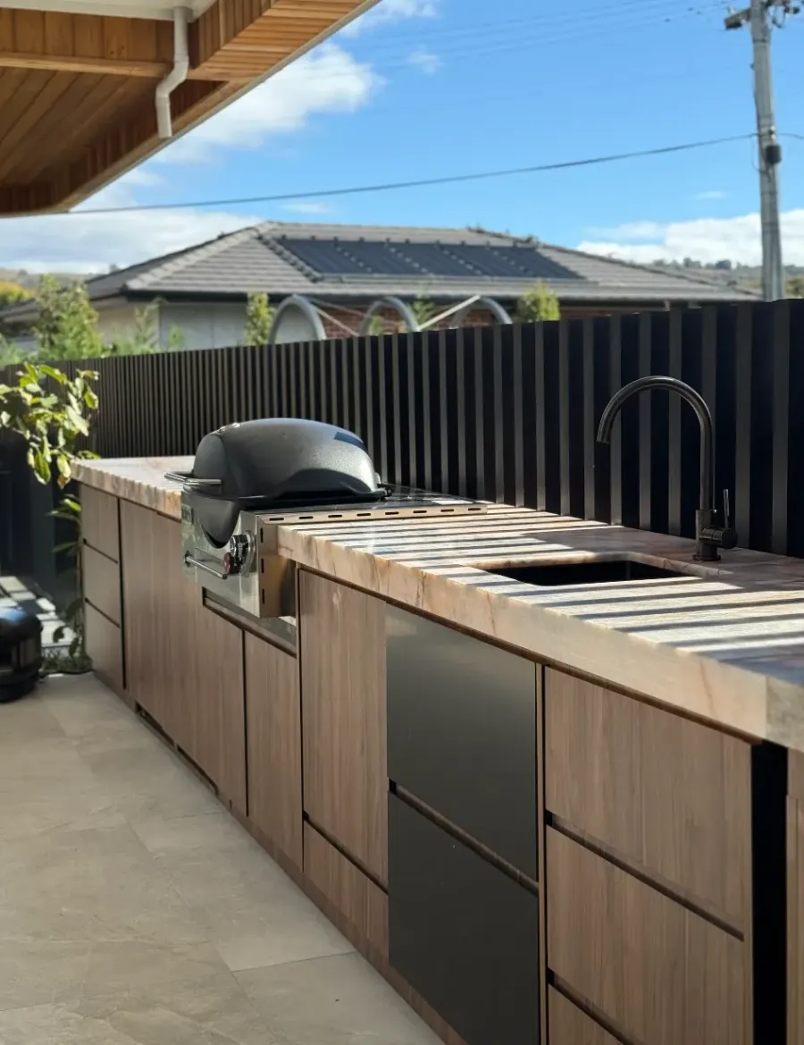 Outdoor kitchen with stone benchtop protected by surface film