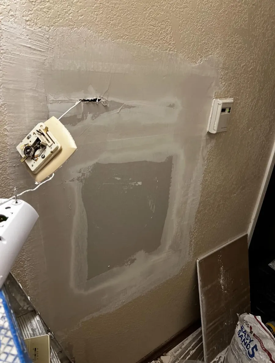 Patch around a thermostat on a textured wall