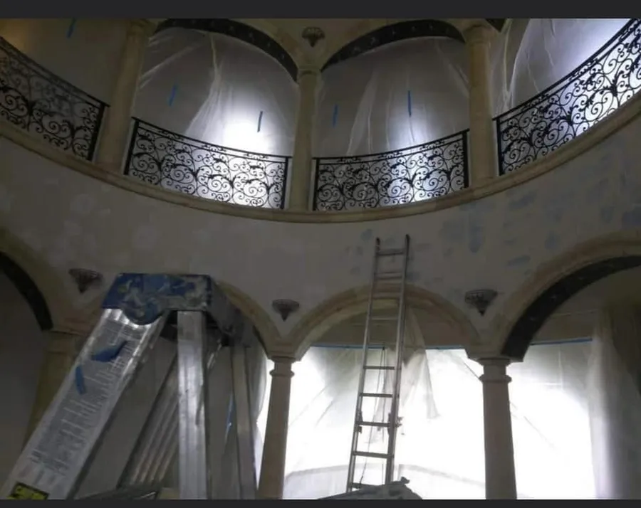 Rotunda with arches and a balcony prepped for painting
