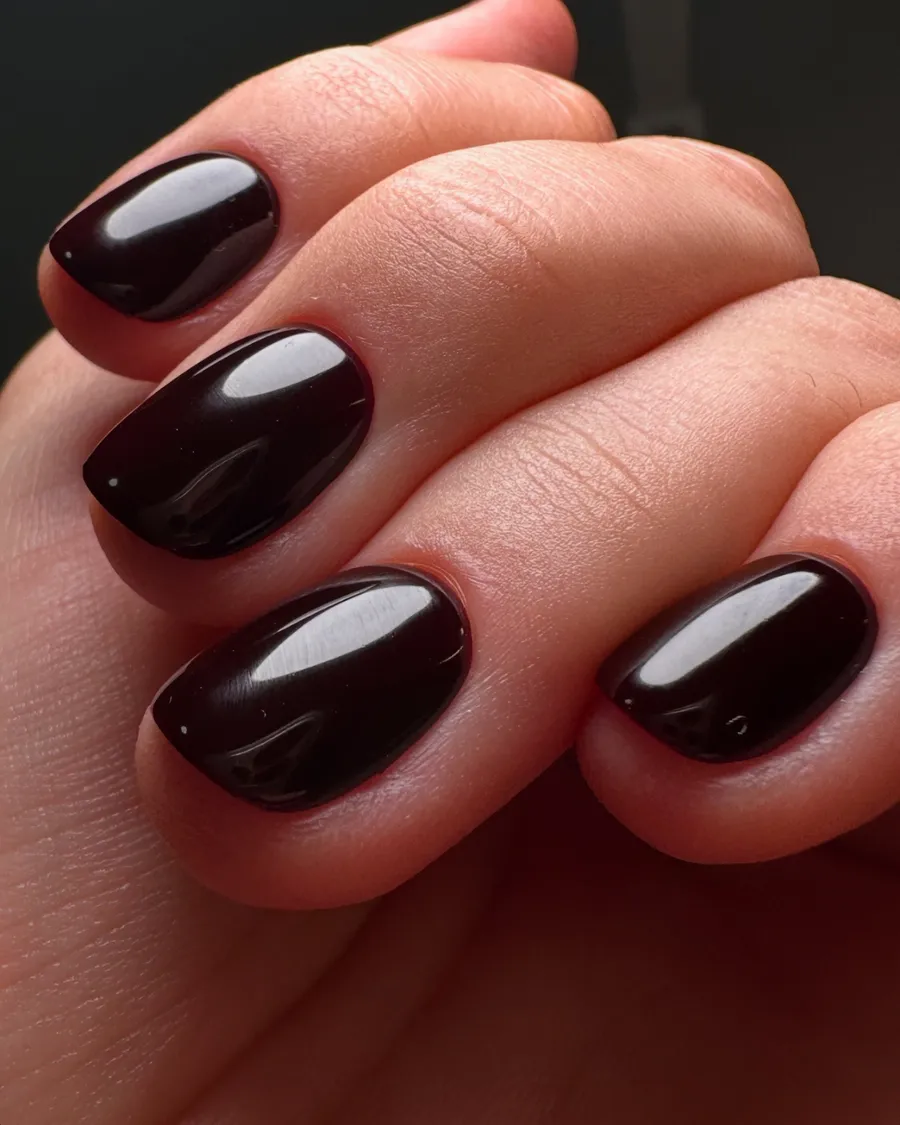 A close up of glossy dark press on nails