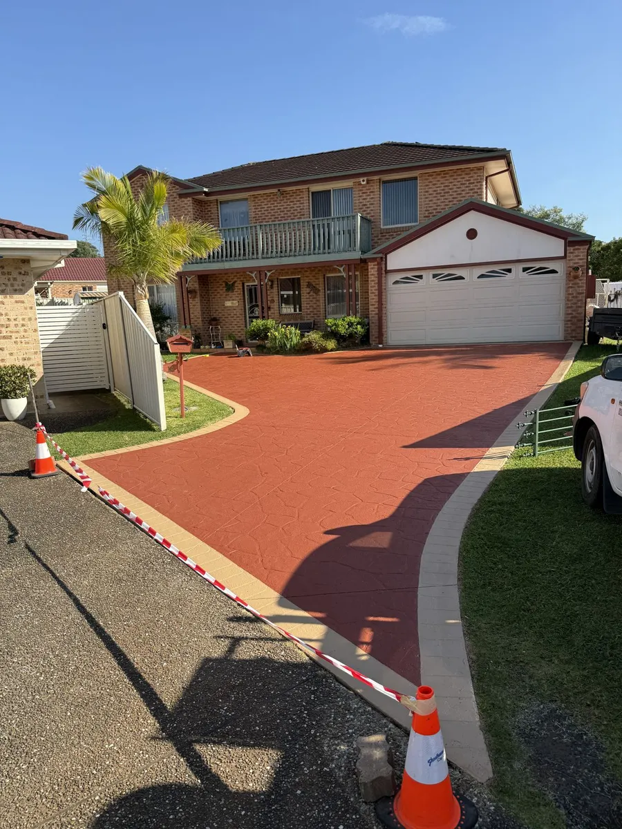 Stamped concrete driveway after cleaning and colour sealing