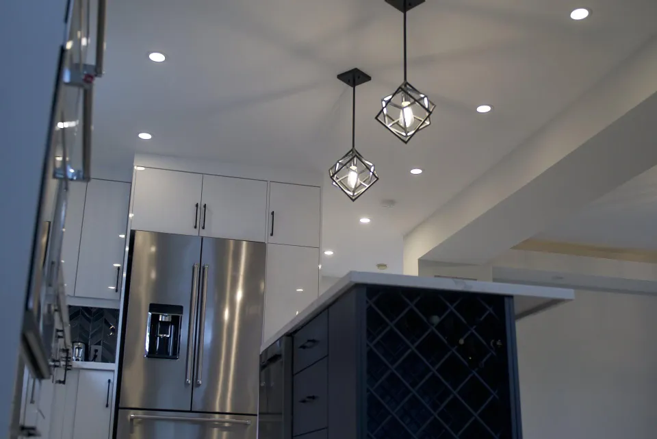 Kitchen with stainless fridge, pendant light and wine storage island