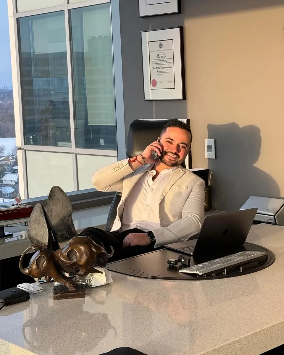 Avi Grondin on the phone at his desk