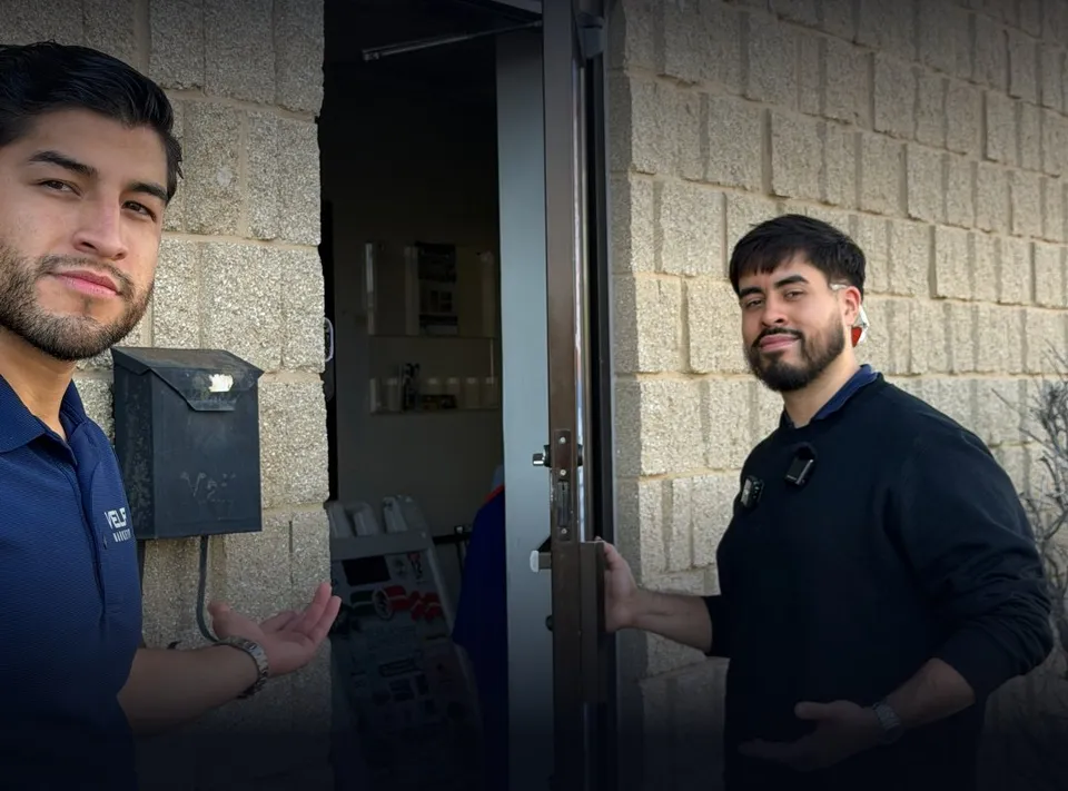 Angel and Cesar from VELPI holding the door open at a local business