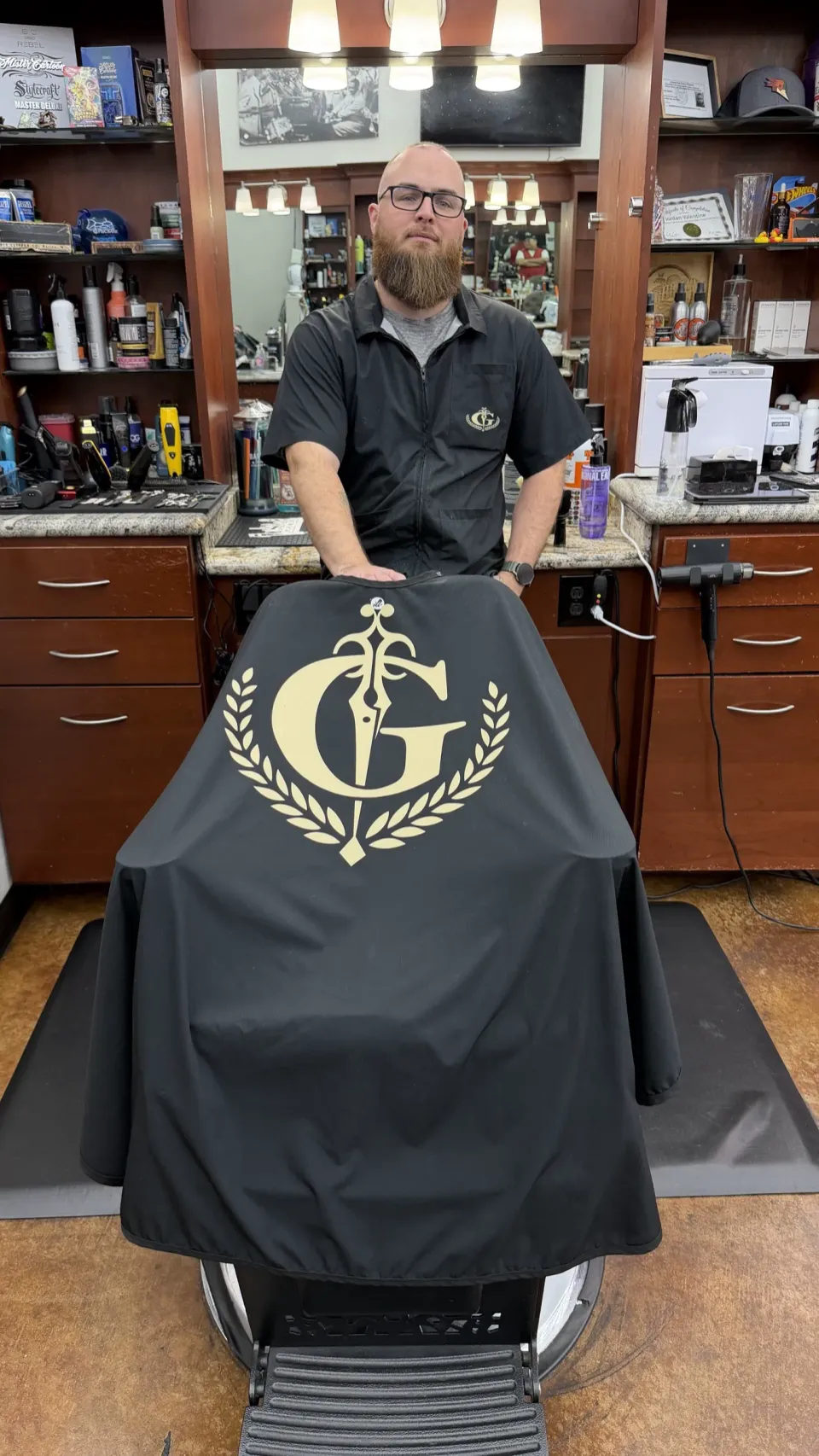 Jordan at his station holding the Gentlemen's Cutz cape