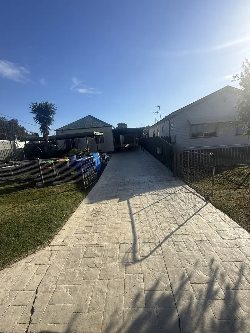 Long stencilled driveway faded and dirty before sealing