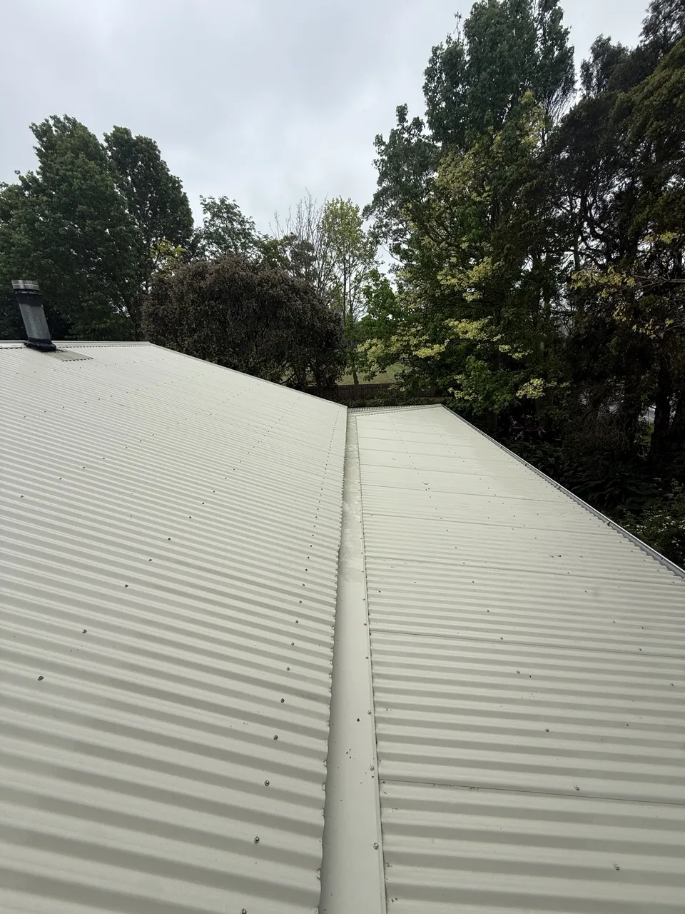 The same metal roof clean after a low-pressure wash