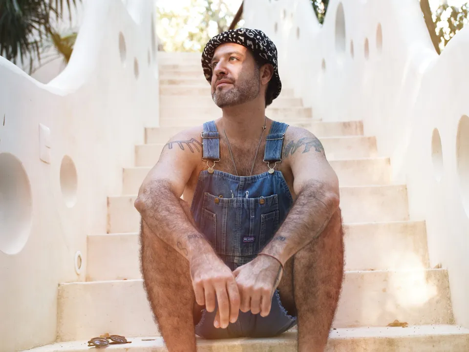 Chef Zander sitting on white stairs