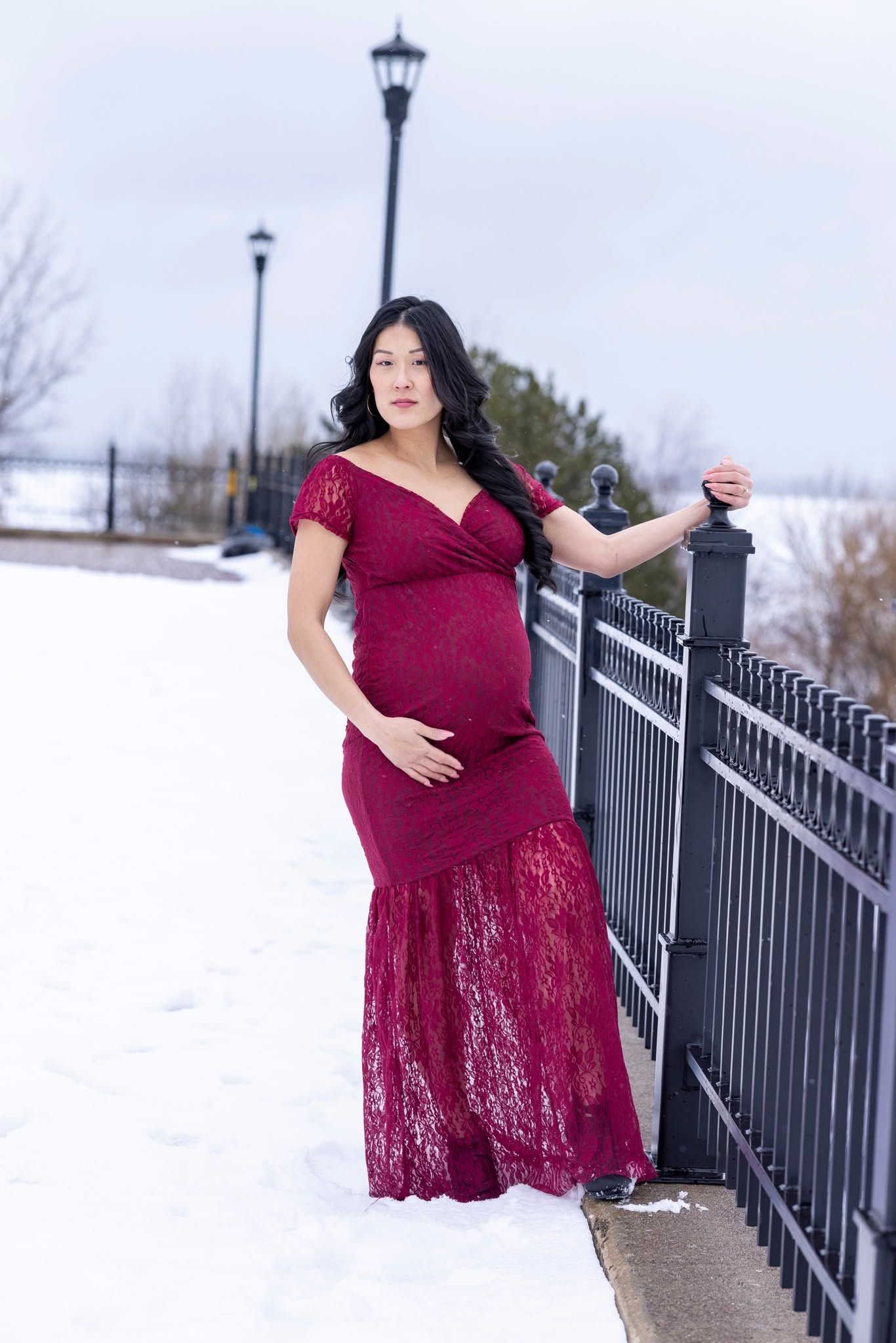 Maternity portrait in a red gown, winter session near Duluth, Minnesota