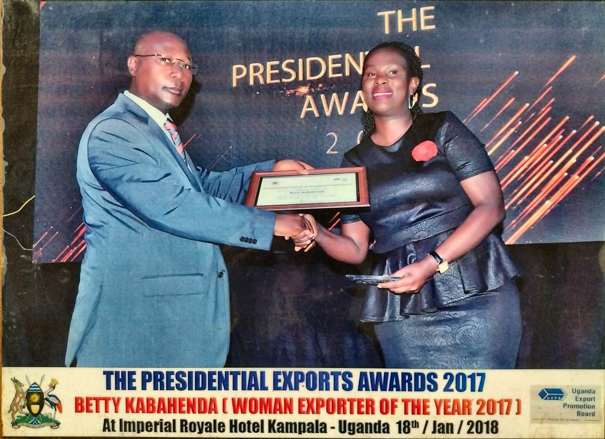 Betty Kabahenda of Mashamba receiving the Woman Exporter of the Year 2017 certificate from a Uganda Export Promotion Board official at the Presidential Exports Awards, Imperial Royale Hotel Kampala, January 2018