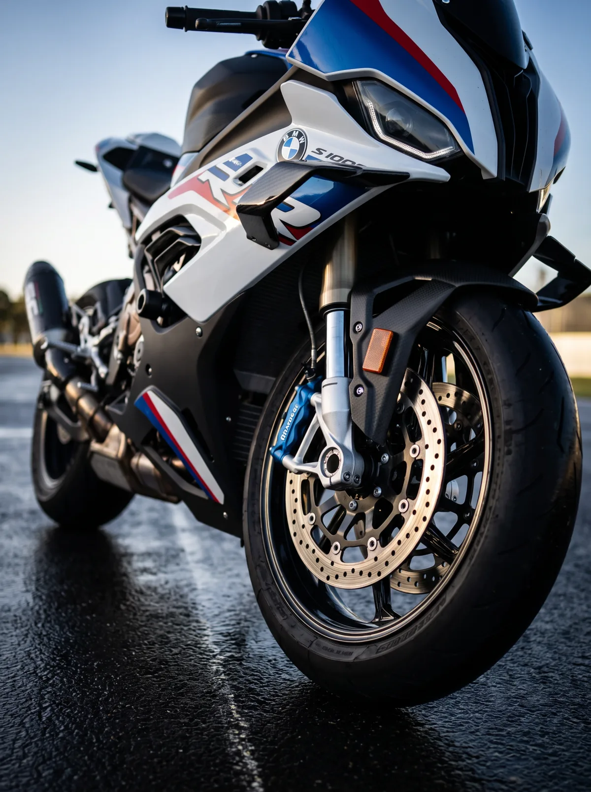 Low front view of the BMW S1000RR front wheel and fairing on wet tarmac