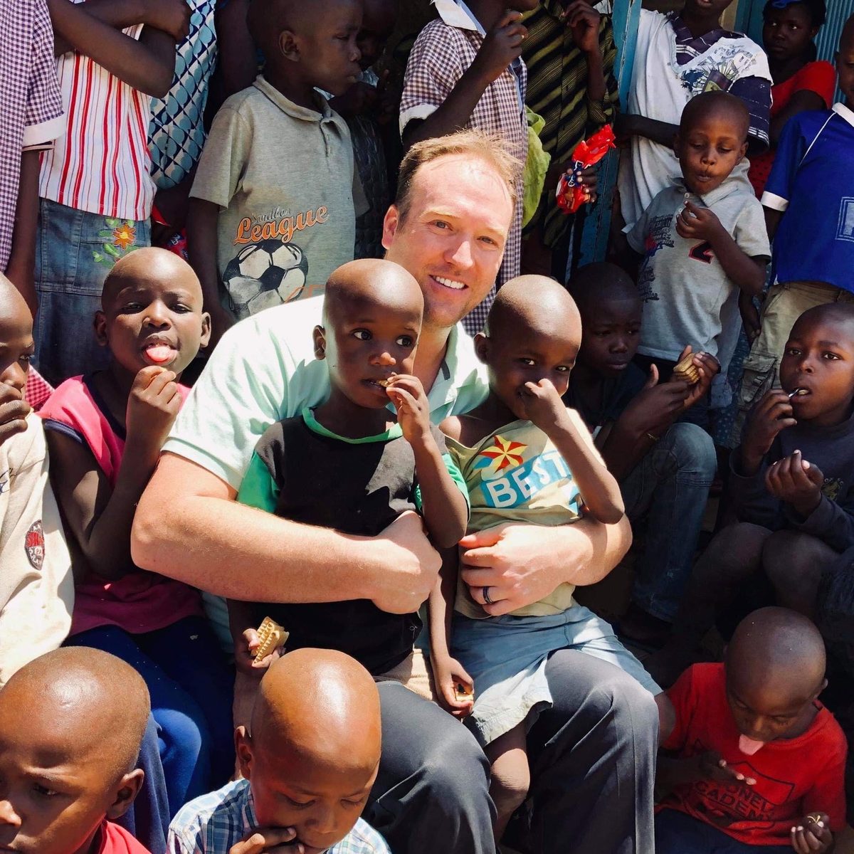 Kevin with children in Africa