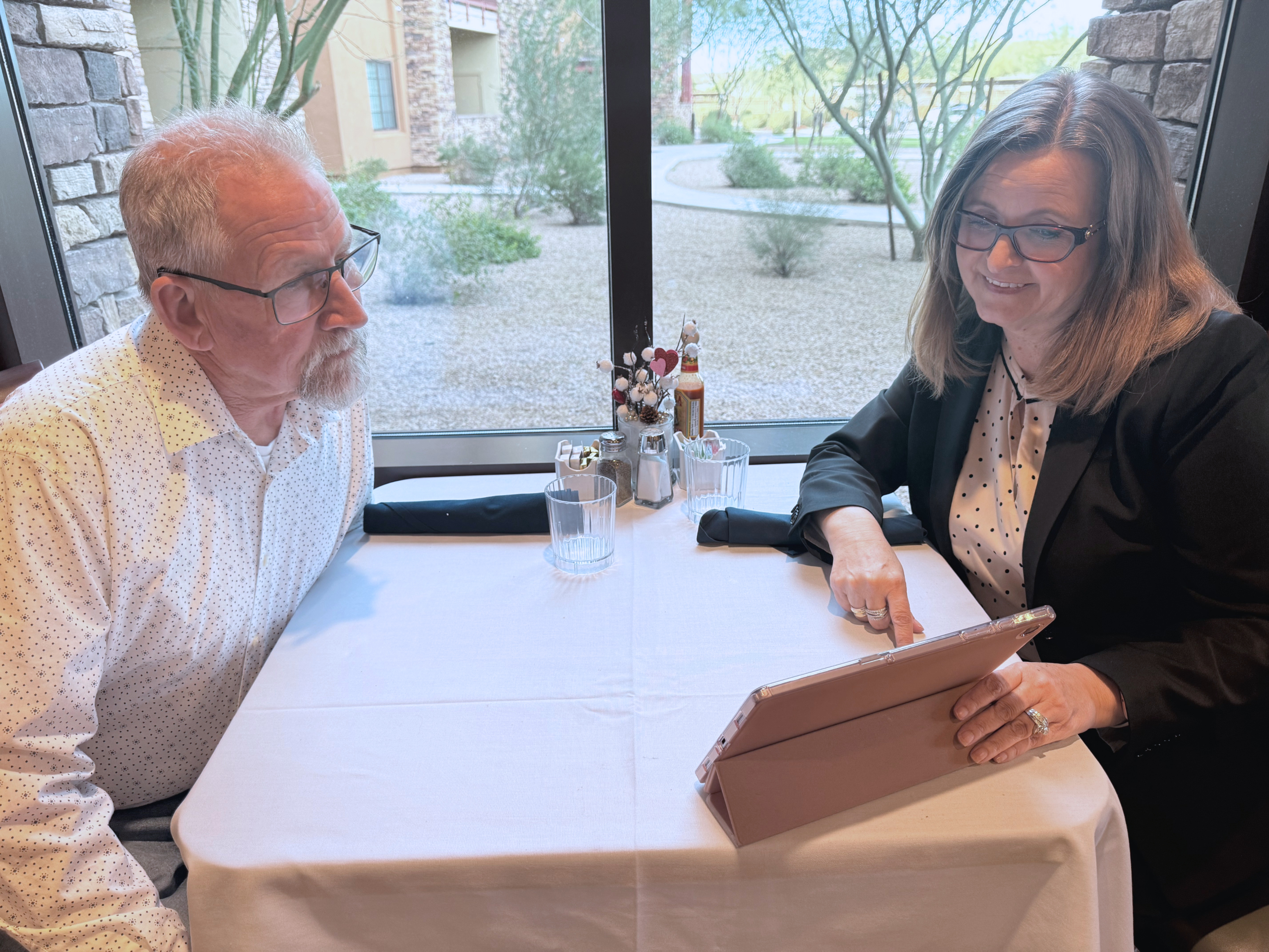 Tiffany Wright reviewing senior living options with a client at a table