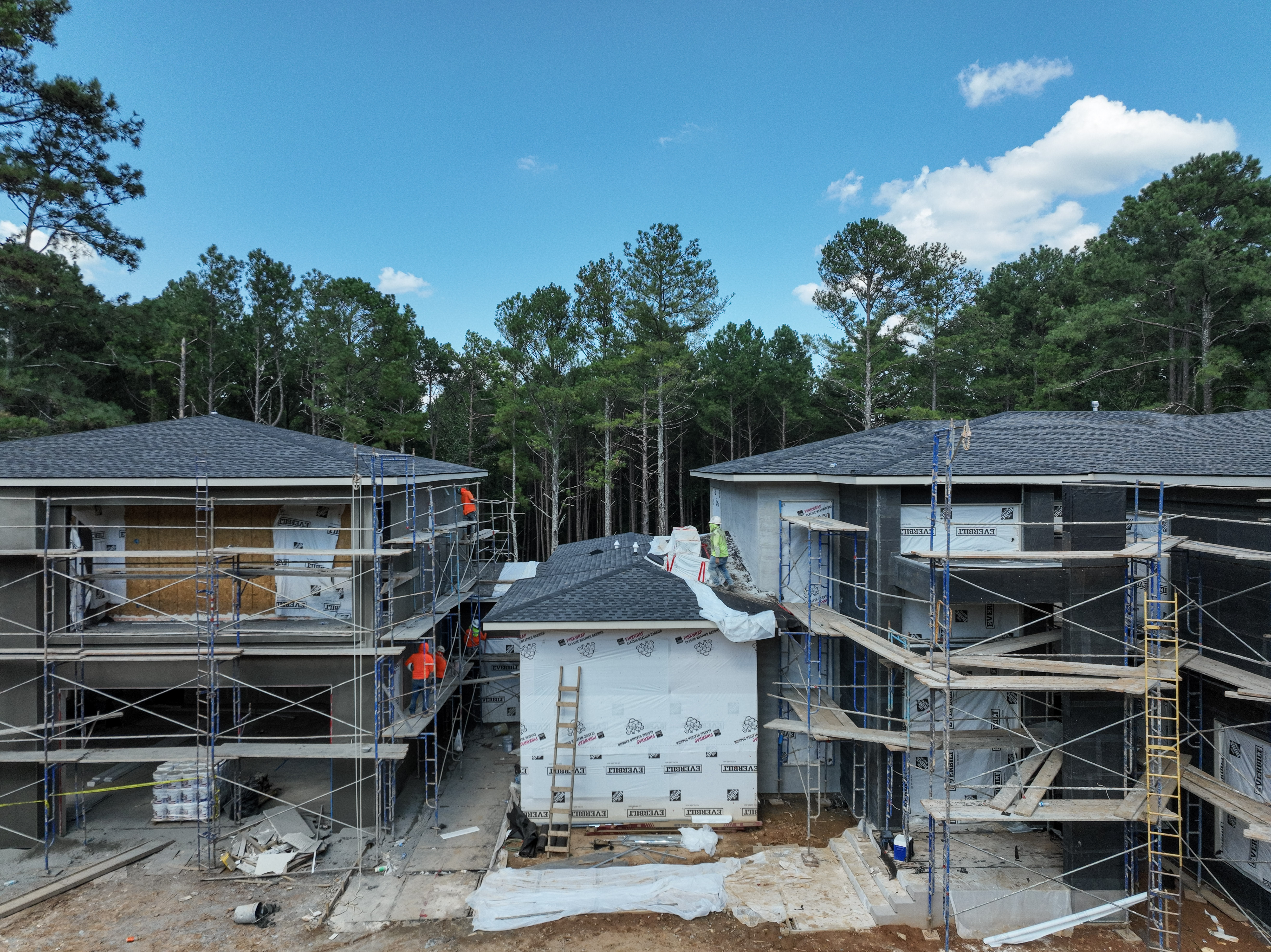 Centered aerial view showing visible exterior work in place at an active construction site