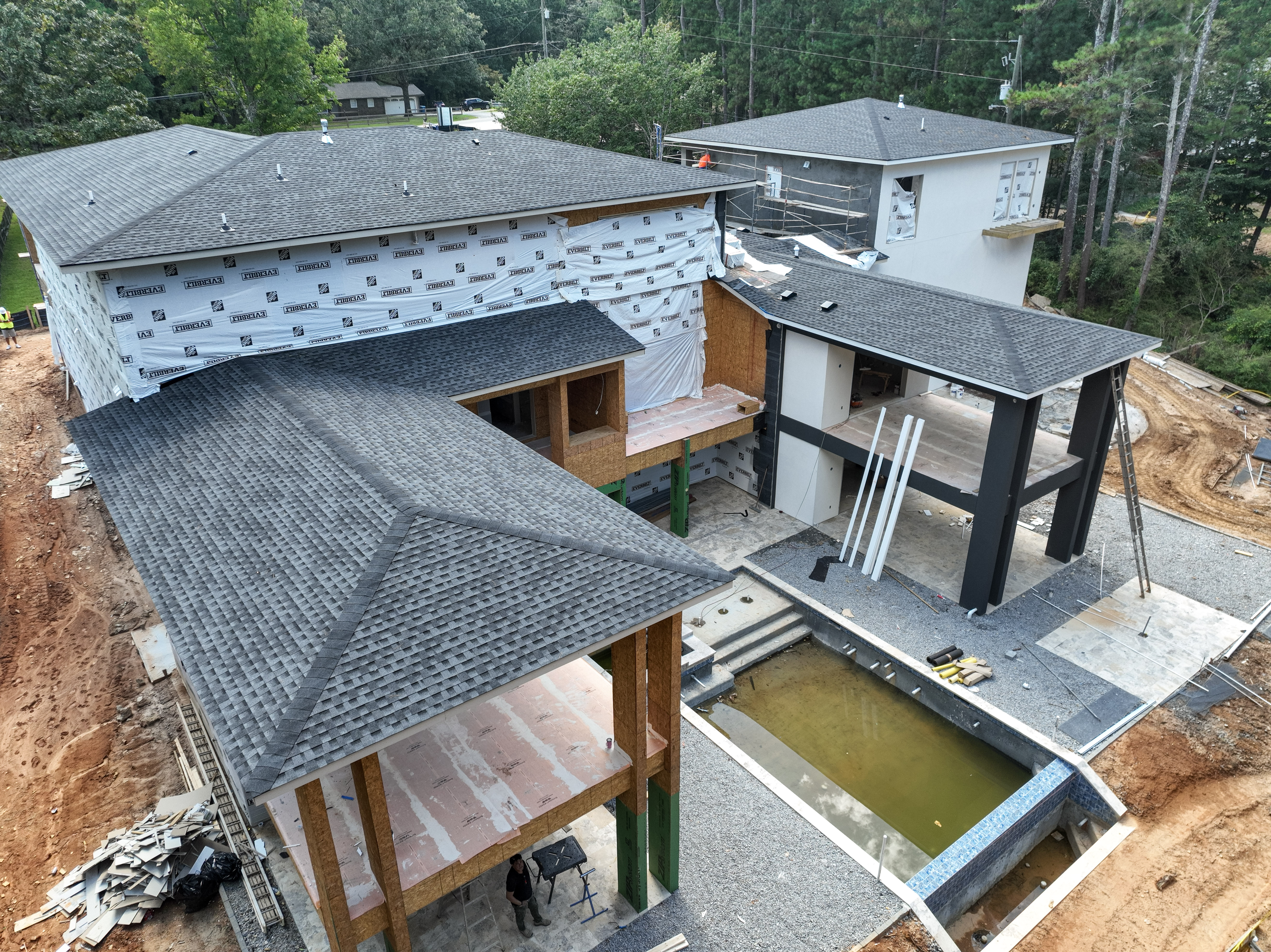 Aerial oblique view showing pool and courtyard construction conditions