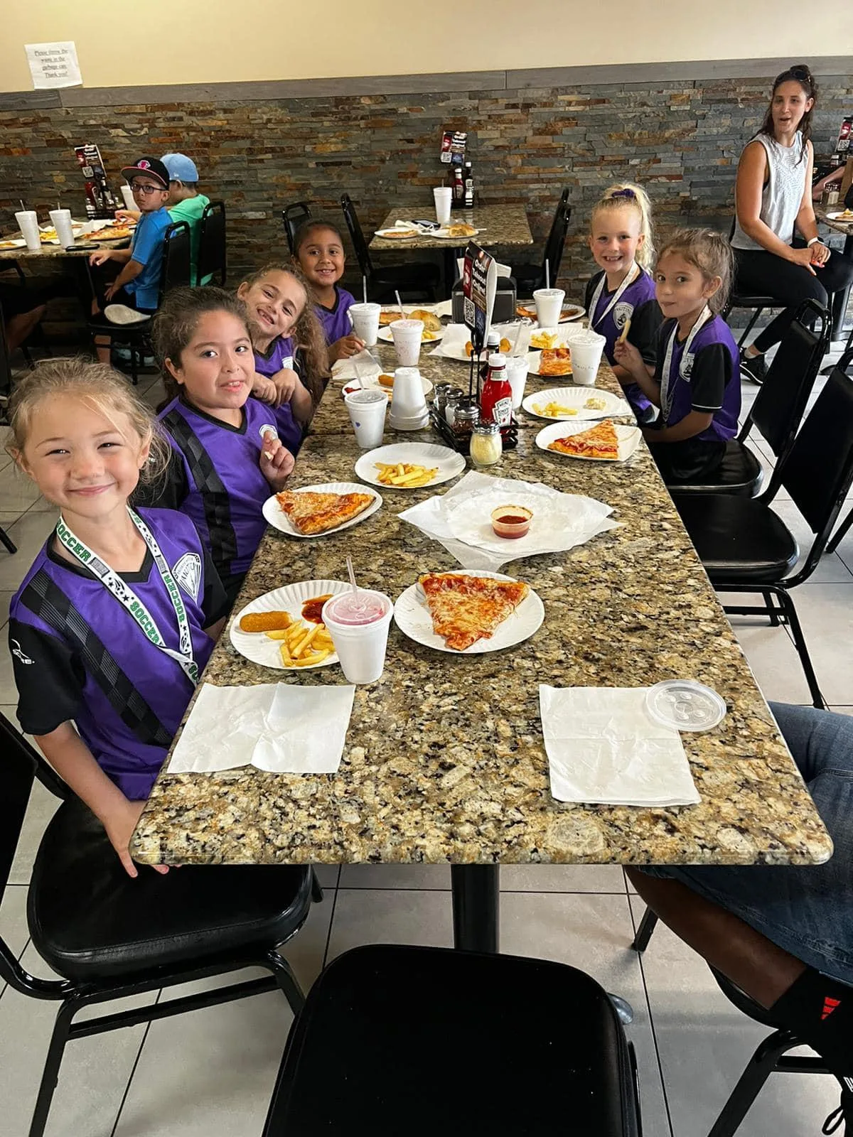 Neighborhood kids enjoying pizza night at Marina's