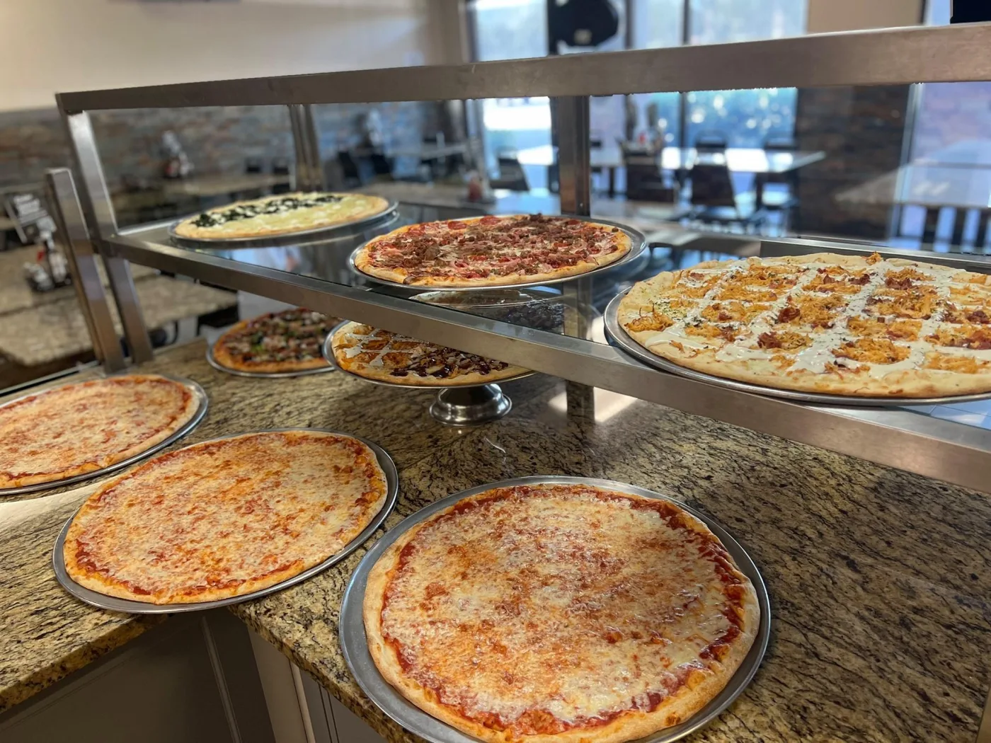 Fresh pizzas lined up at Marina's