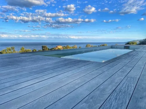 Piscine avec terrasse bois et horizon m&eacute;diterran&eacute;en