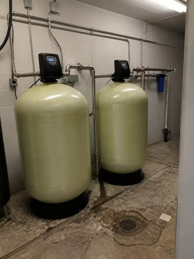 Commercial water softener system with stainless steel pipes installed in a mechanical room in Mesa, AZ.