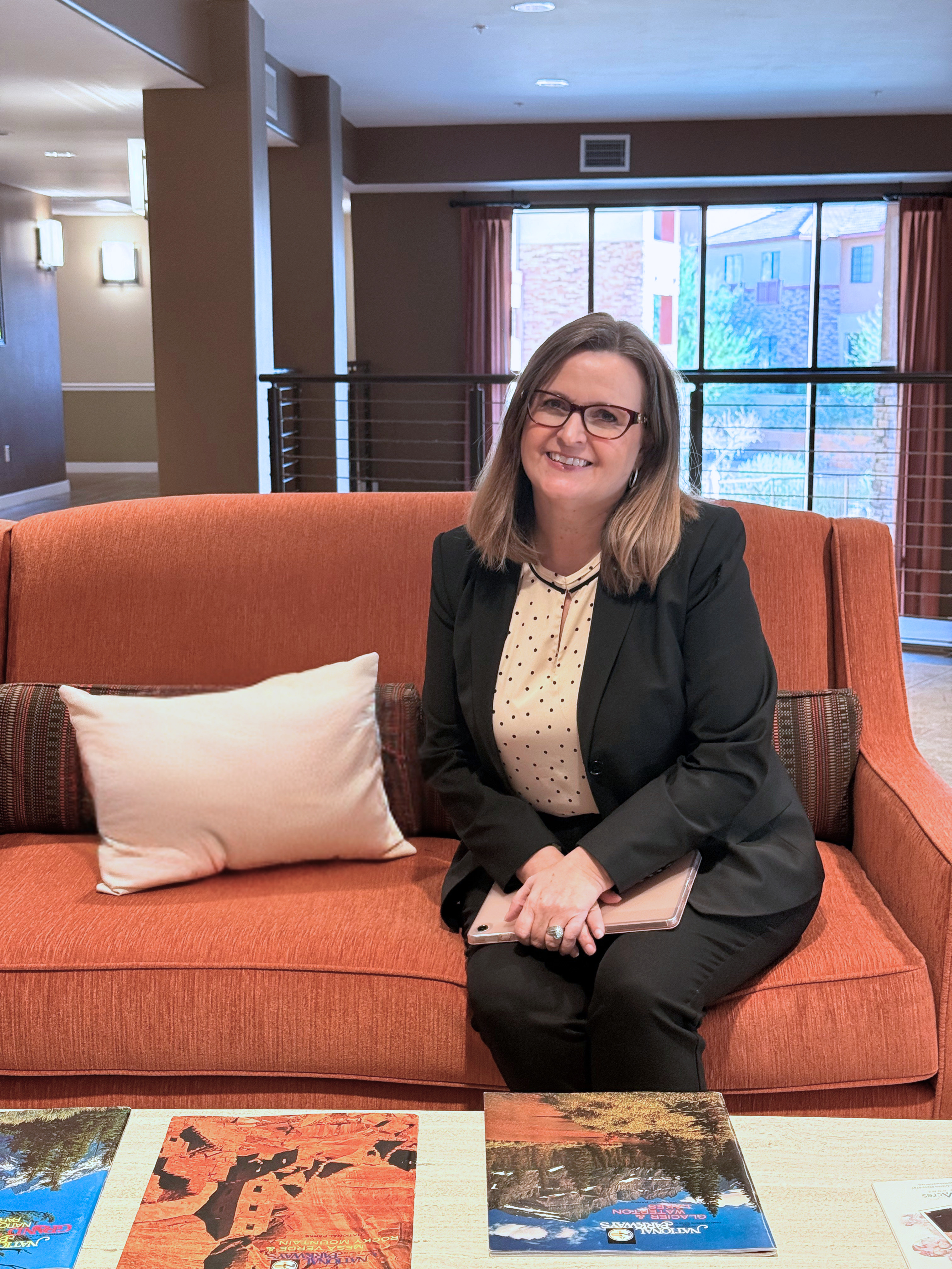 Tiffany Wright seated in a senior living community lobby