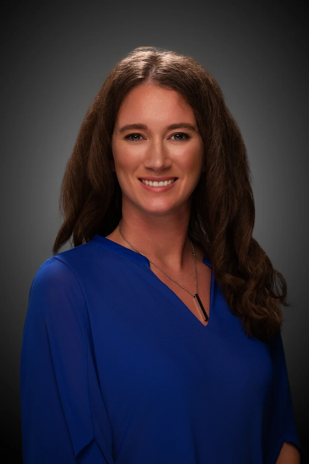Ashly Balza smiling in a blue blouse