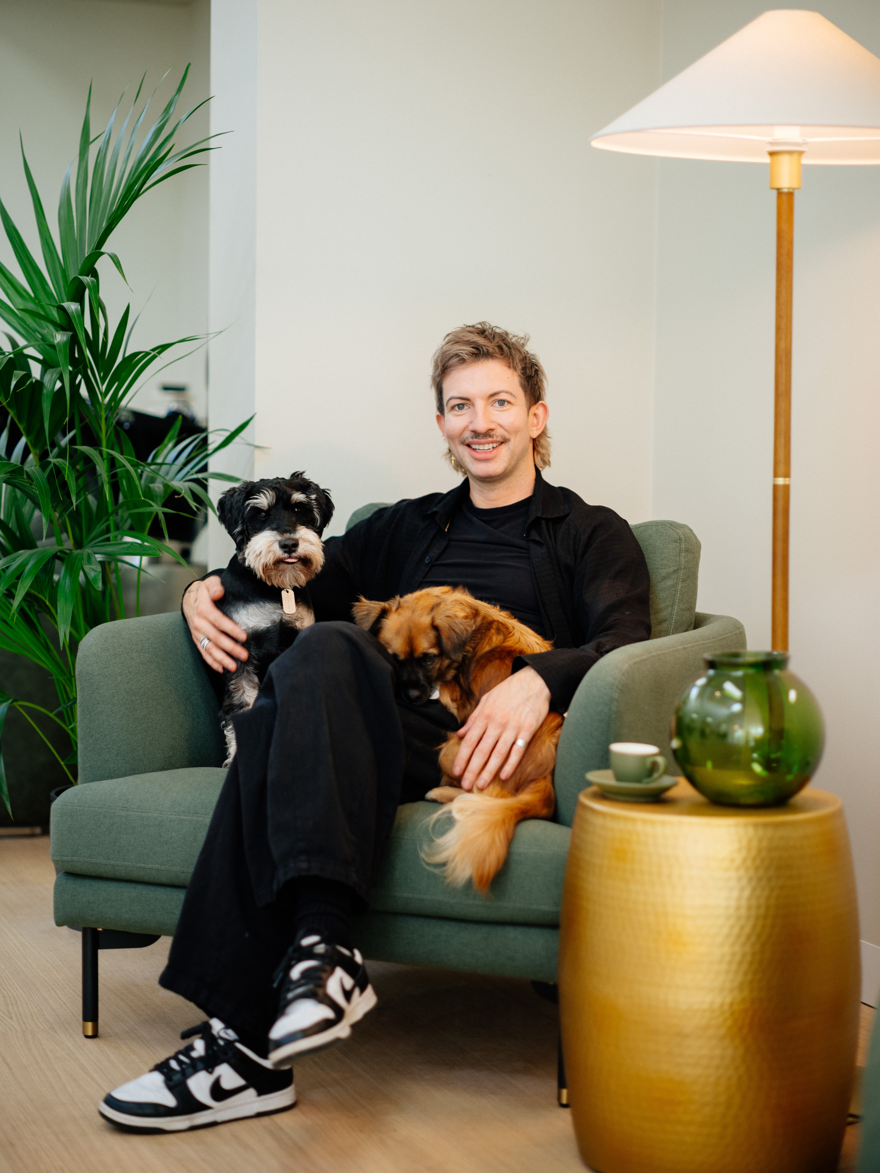 A happy BIBA Croydon client smiling, surrounded by plants