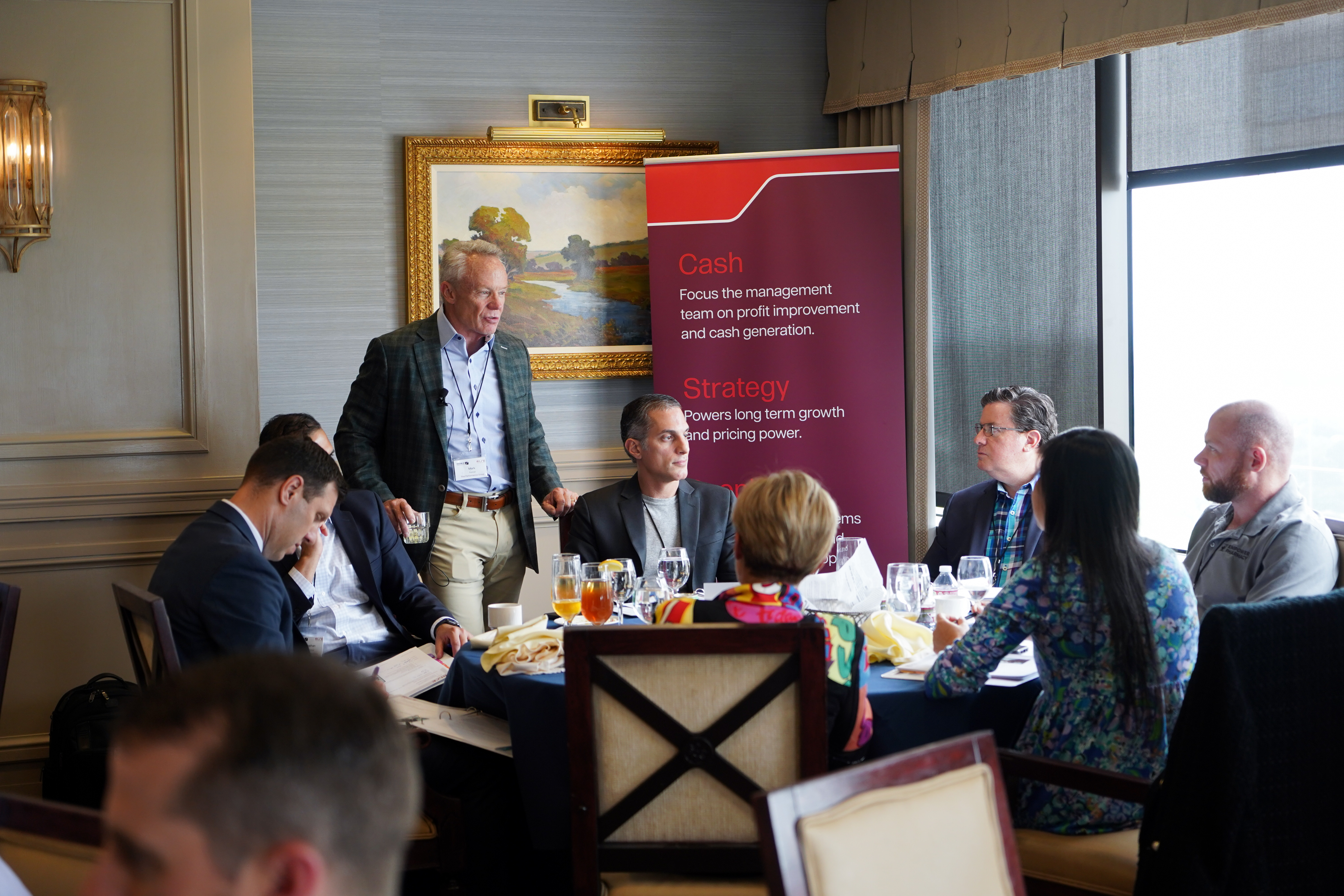 Mark Fenner, Scaling Up coach working with a table of executives for high-growth company.