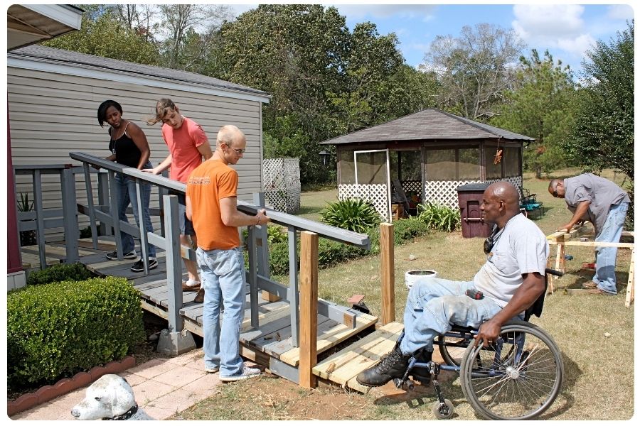 Volunteers adding railing to safety ramp
