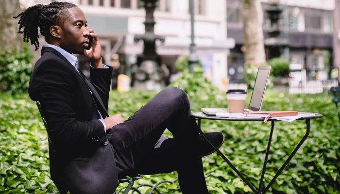 Image of a man doing a business call in the park