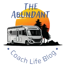 Logo of The Abundant Coach Life with picture of motorhome, trees and sunset