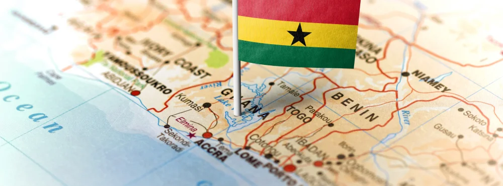 Map of Ghana with its flag on top