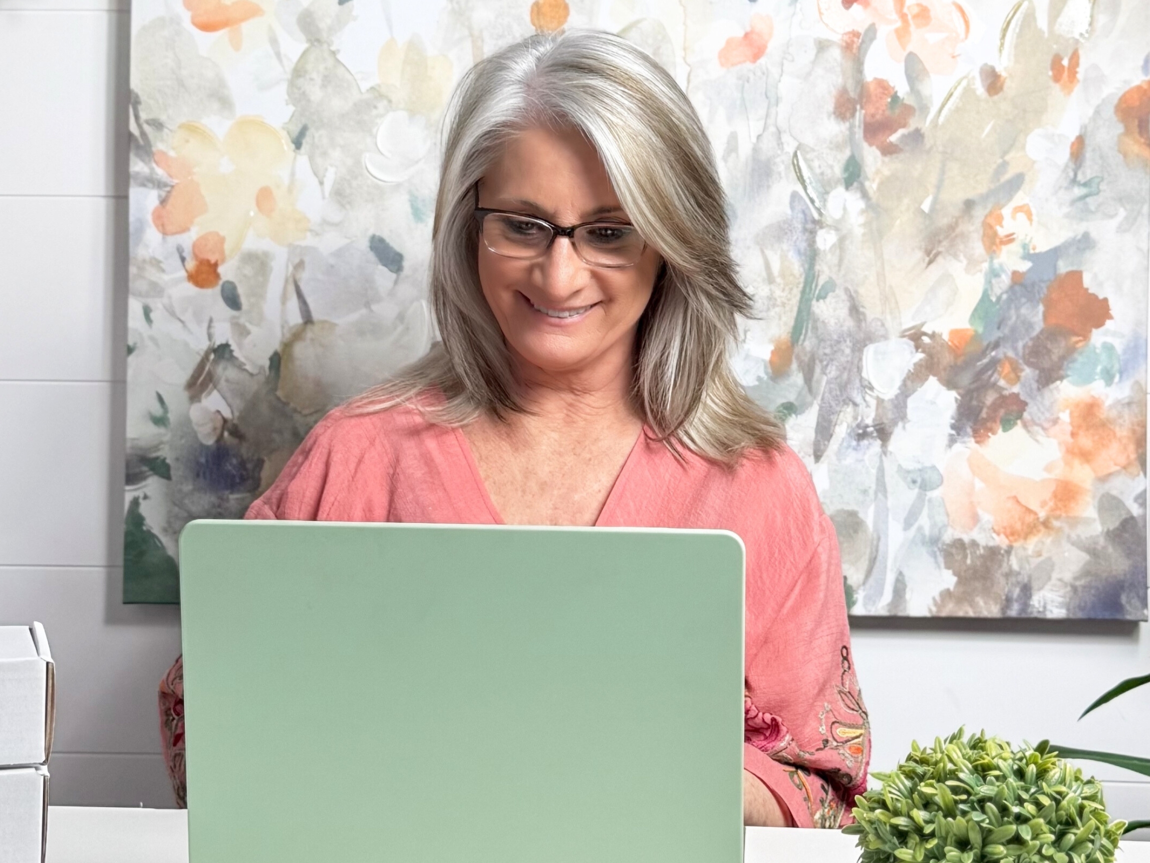 Image of woman using laptop at desk
