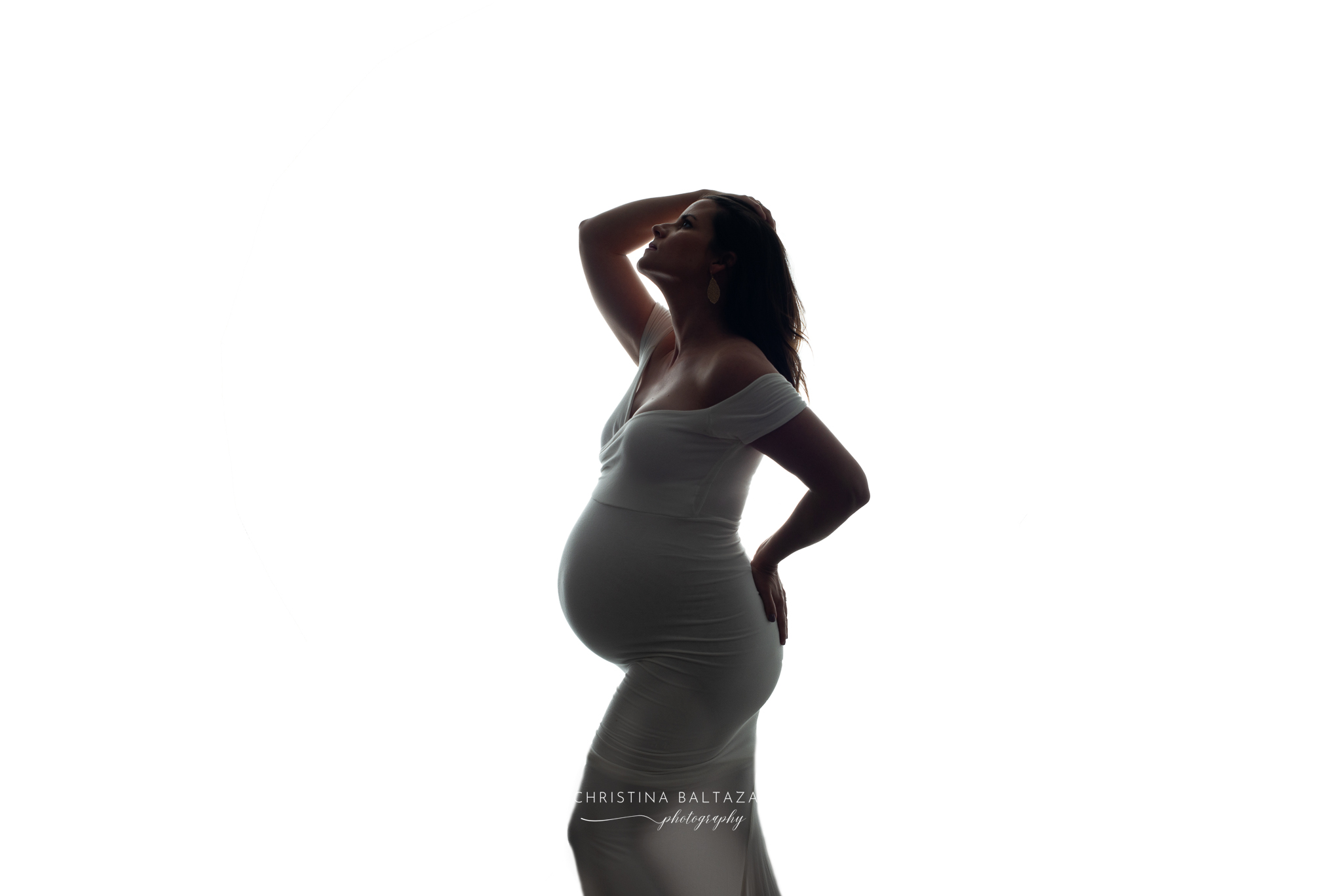 Pregnant woman in white gown