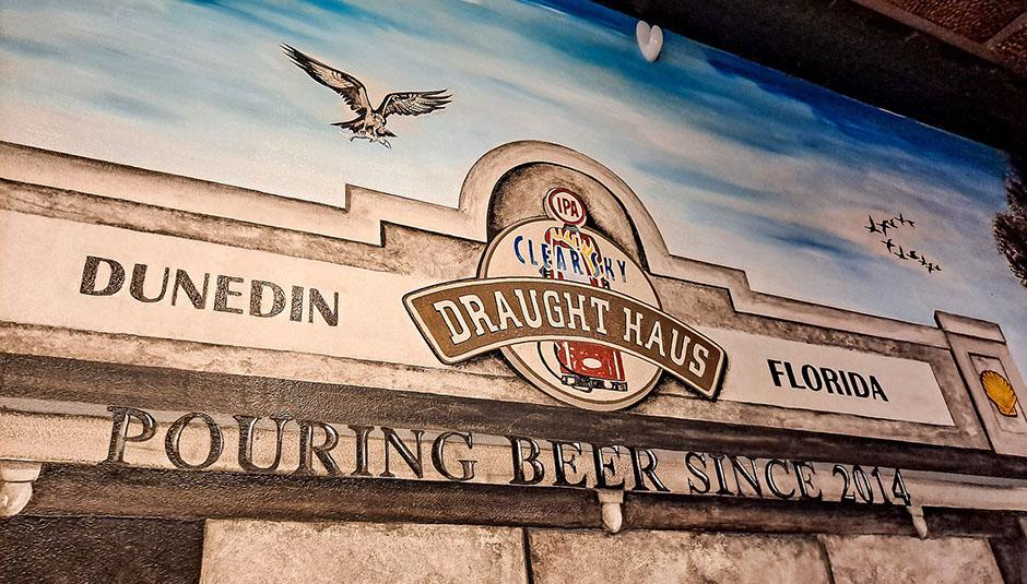 Hand-lettered signage painted on a Dunedin building fascia