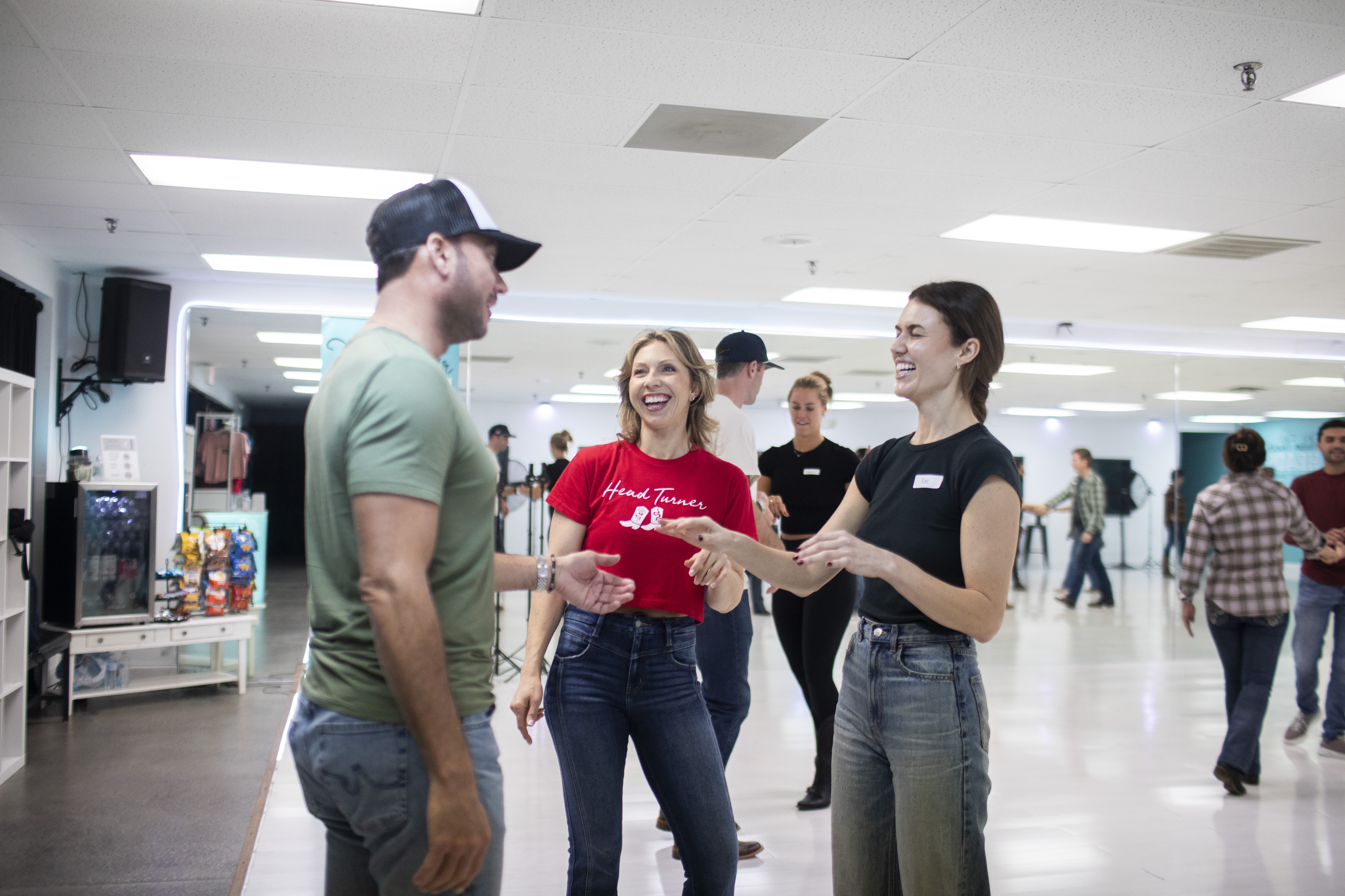 A couple learning Country Swing with an instructor at Turn Their Heads