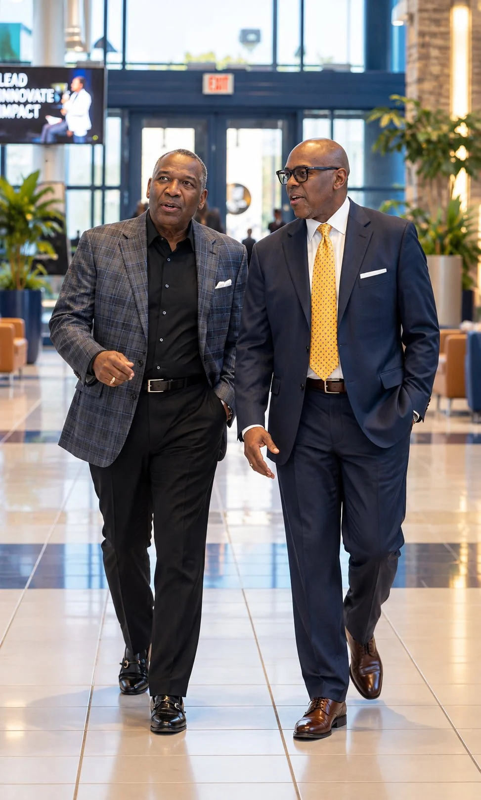 Dr. Mikel Brown in conversation with a fellow leader