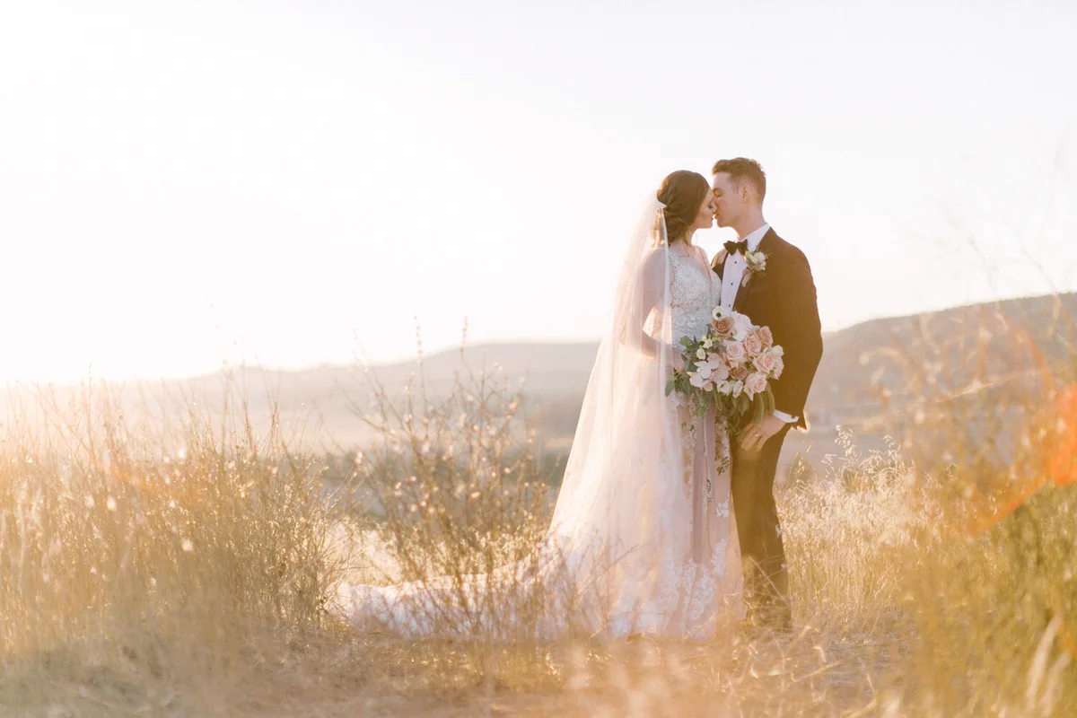 Couple embracing in golden evening light in the foothills