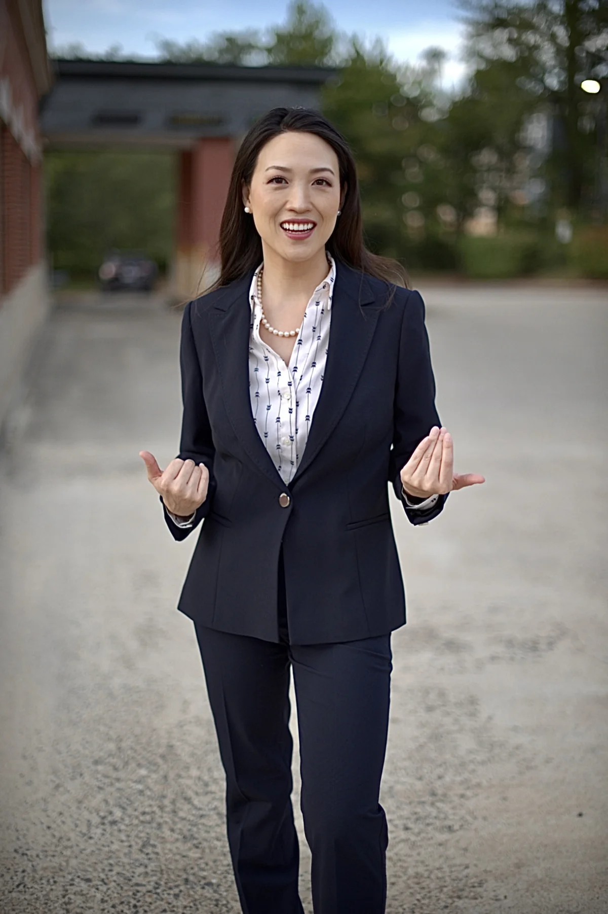 Dr. Sarai Koo with open hands, ready to talk