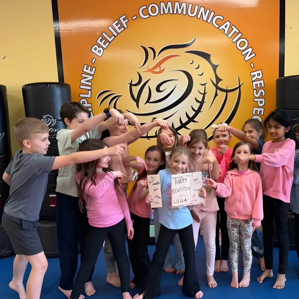Group of birthday guests celebrating together at a Mastery Martial Arts school
