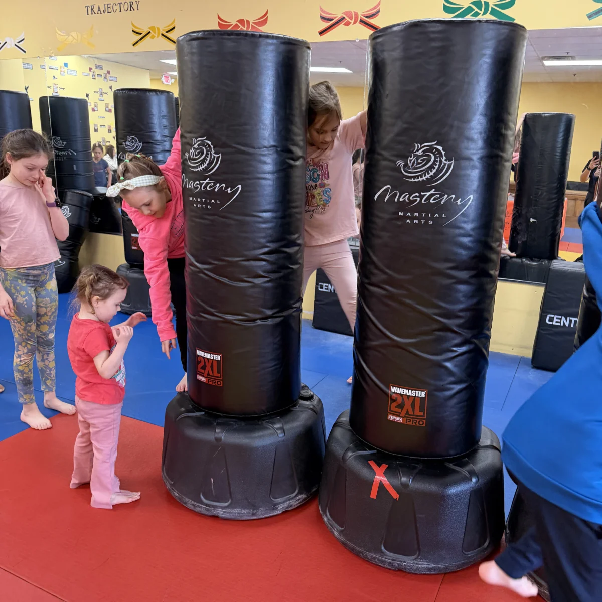 Children taking turns on the Mastery training bags during a birthday party