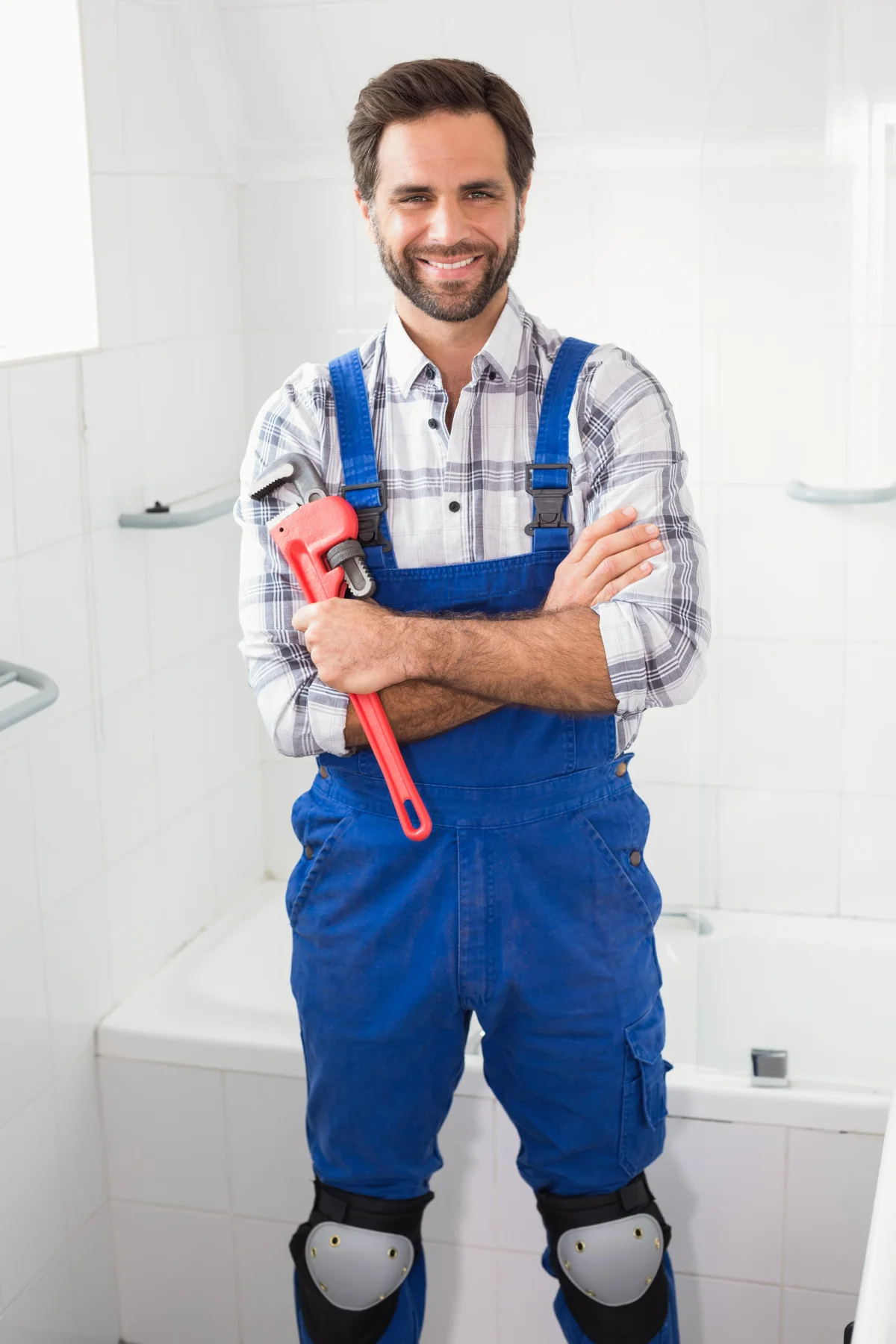 Master plumber holding a wrench, ready for a residential install
