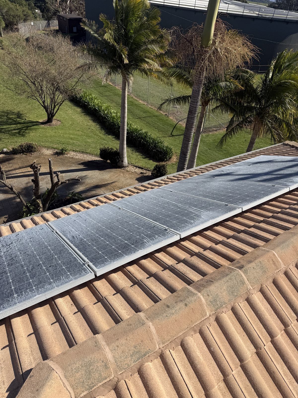 Solar panels before professional cleaning, showing dirt and build-up